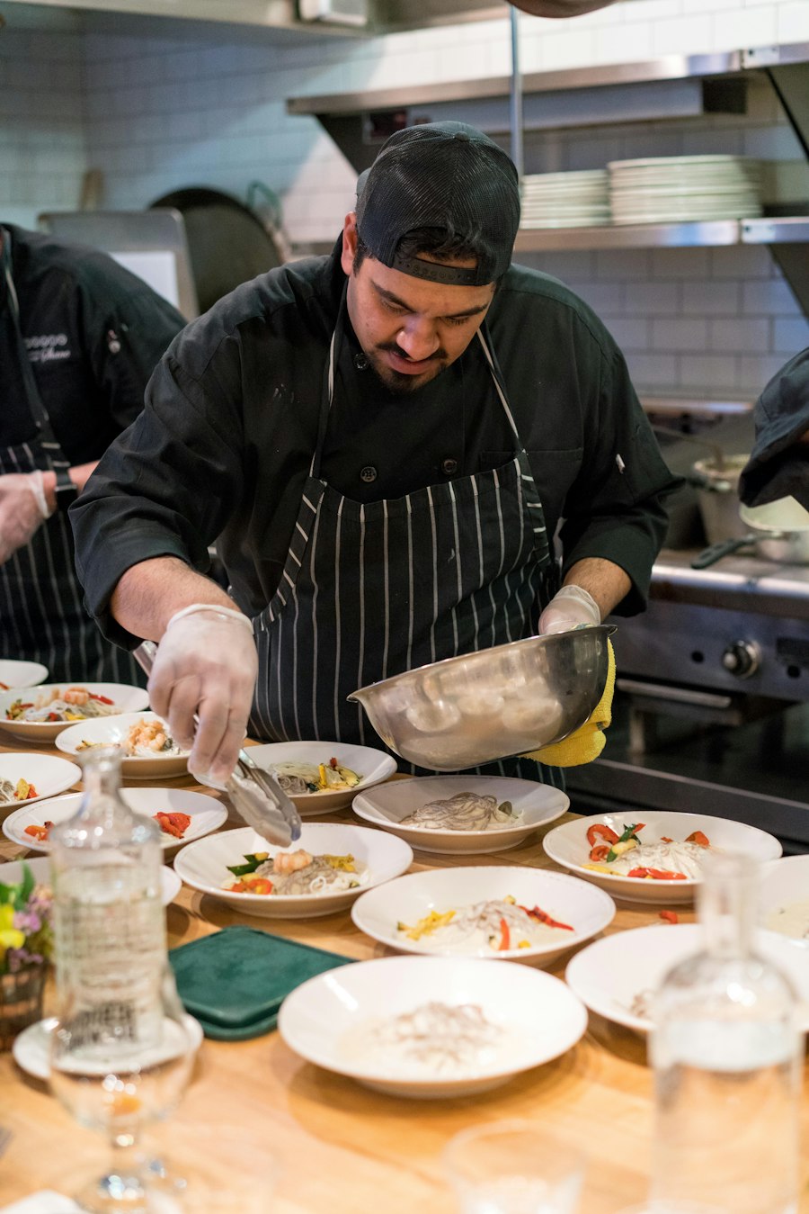 Chef plating dishes on a busy line
