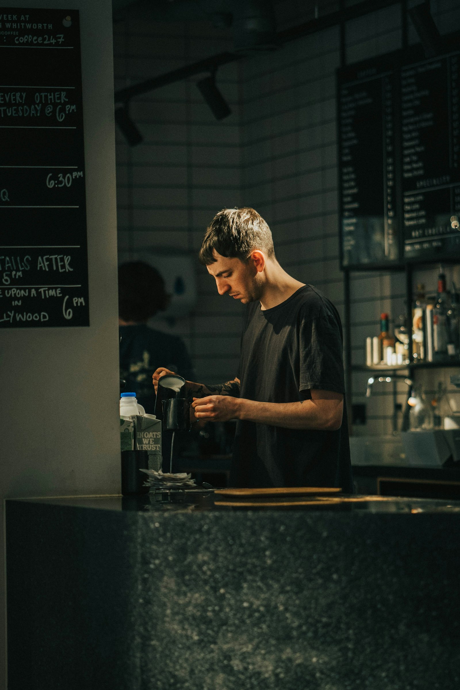 Barista working behind the counter at night