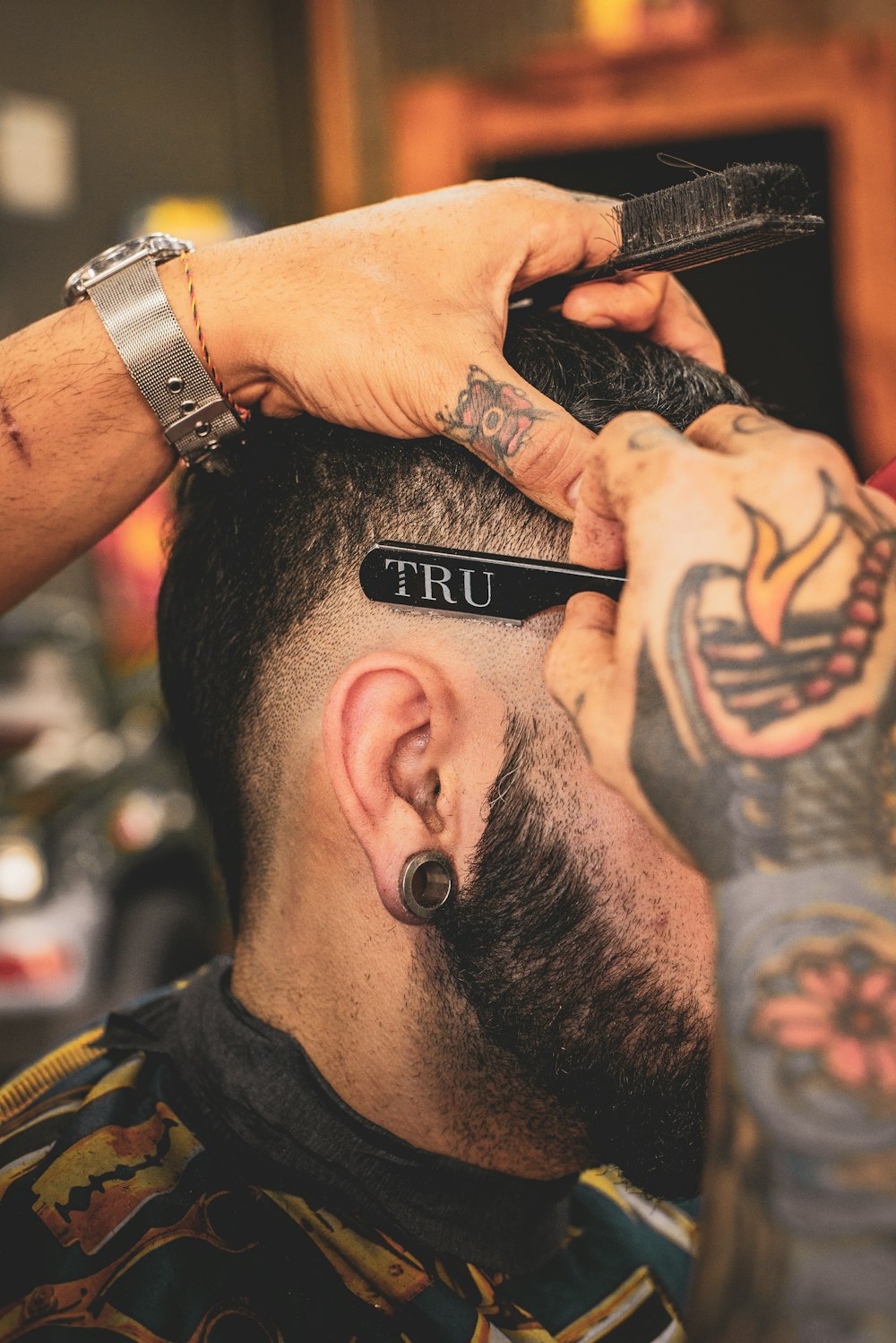 Barber shaving a client with a straight razor